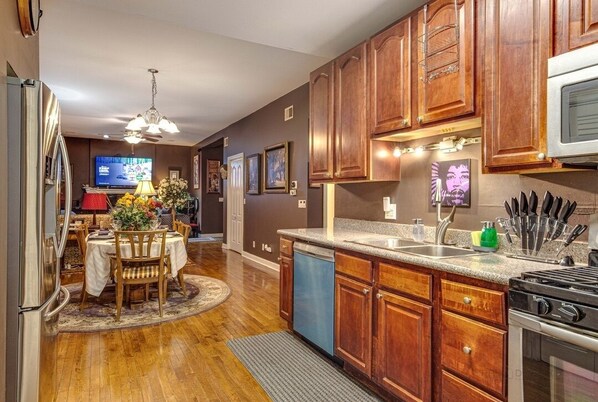 Enjoy cooking in this well-appointed kitchen with a gas stove, refrigerator, and dishwasher.
