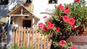 A building with a wooden staircase, a wooden fence, and a sign that reads "Gasthof". - Gasthaus Pension Augenstein (Winzer)
