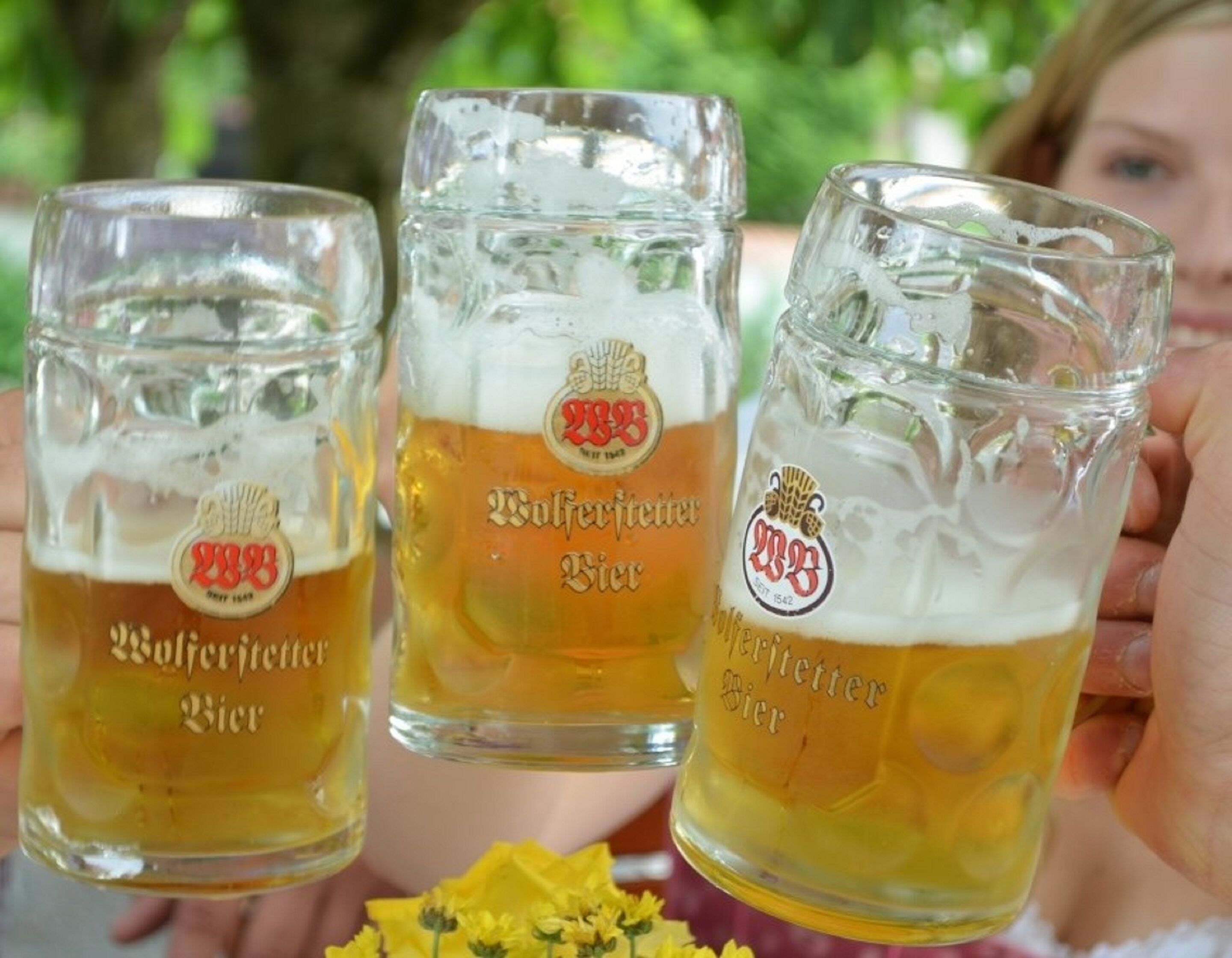 Three glass mugs of beer with the logo "2333" and the text "Bier".