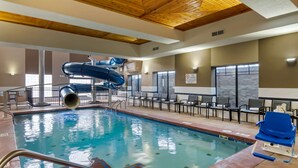 A pool area with a water slide, lounge chairs, and a 'No Diving' sign. - Best Western Premier Liberty Inn & Suites (Liberty)