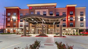 A hotel with a modern design, featuring a covered entrance and a prominent signage. - Best Western Premier Liberty Inn & Suites (Liberty)