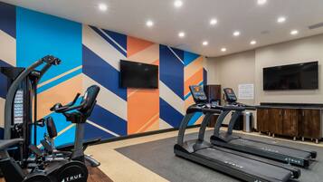 A gym with treadmills, a stationary bike, and a weight machine.