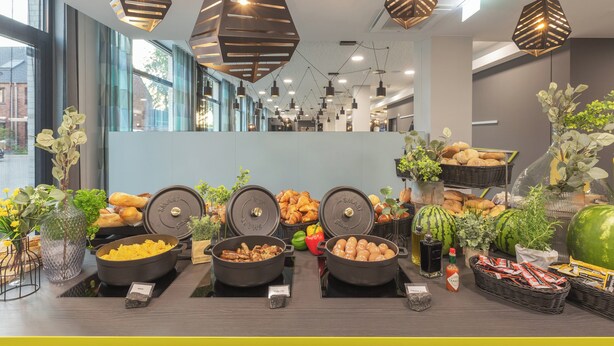 A buffet area with various food items, including fruits, pastries, and condiments. - Holiday Inn - the niu, Seven Dusseldorf Ost by IHG (Düsseldorf)