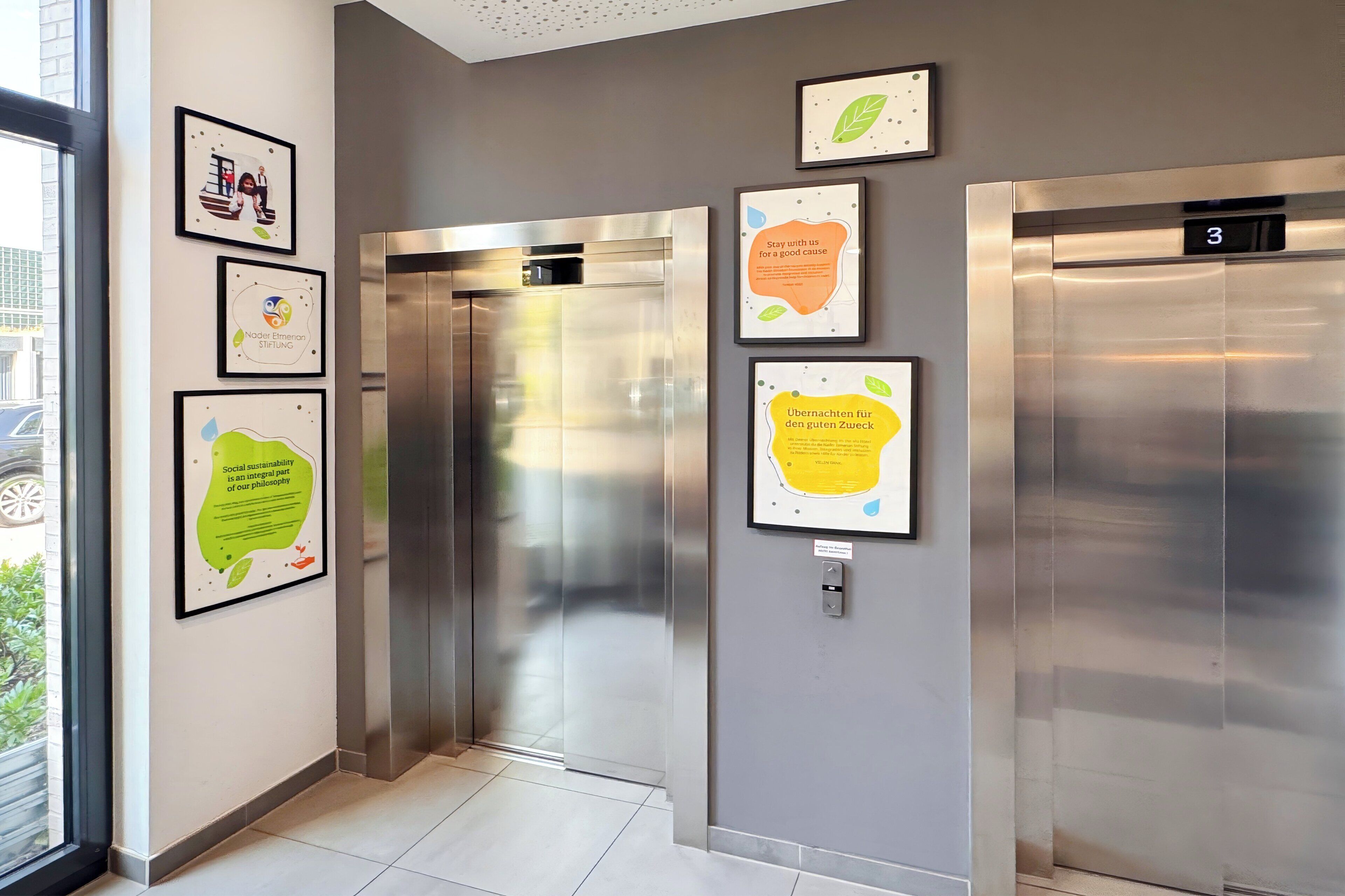 An elevator with stainless steel doors and a digital display showing the number 3.