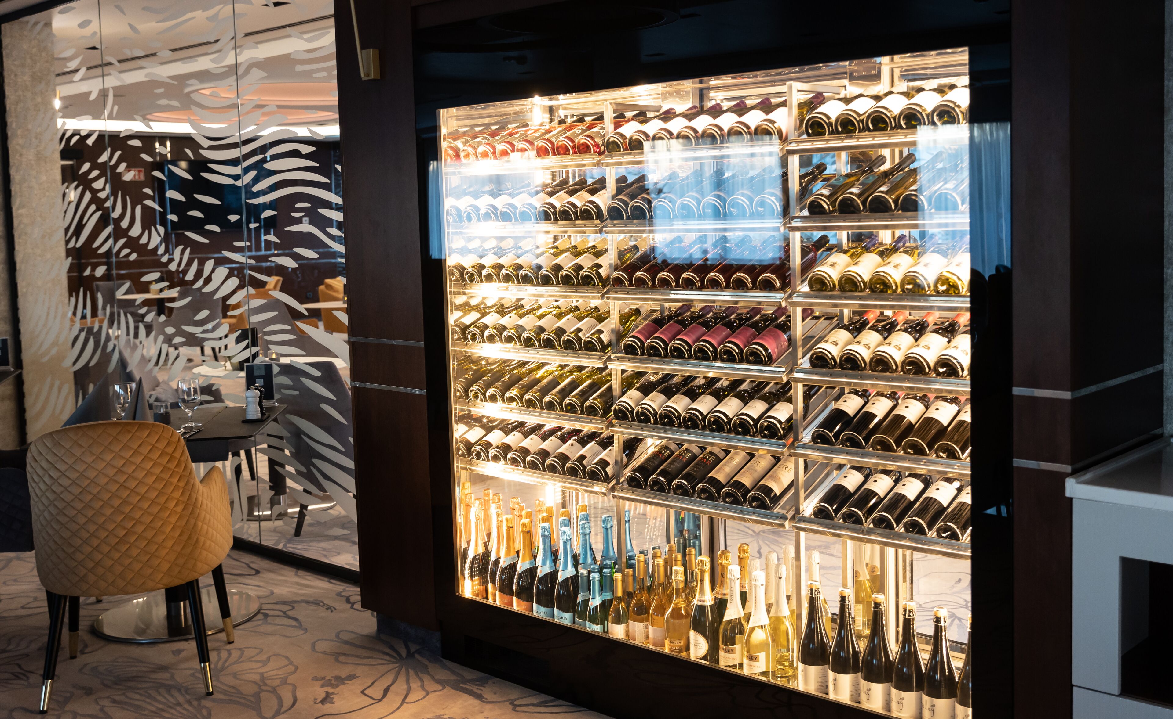 A wine cellar with shelves of wine bottles.