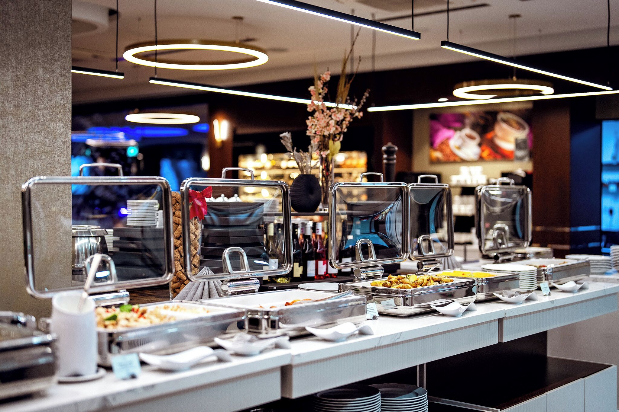 A buffet setup with multiple serving stations, including trays of food and beverages.