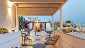 A rooftop terrace with outdoor seating, a dining area, and a view of a church. - Exclusive property with terrace and plunge-pool, Noto, Sicily (Noto)