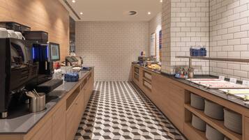 A modern kitchen with a checkered floor, a coffee station, and a buffet area with various food items.