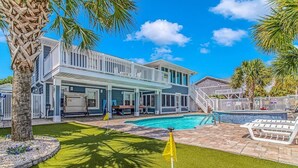A two-story house with a swimming pool, a covered patio, and a fenced backyard. - Vitamin Sea | Second-Row House | Private Pool (North Myrtle Beach)