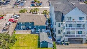 A coastal hotel with multiple floors, a parking lot, and a view of the beach. - Vitamin Sea | Second-Row House | Private Pool (North Myrtle Beach)