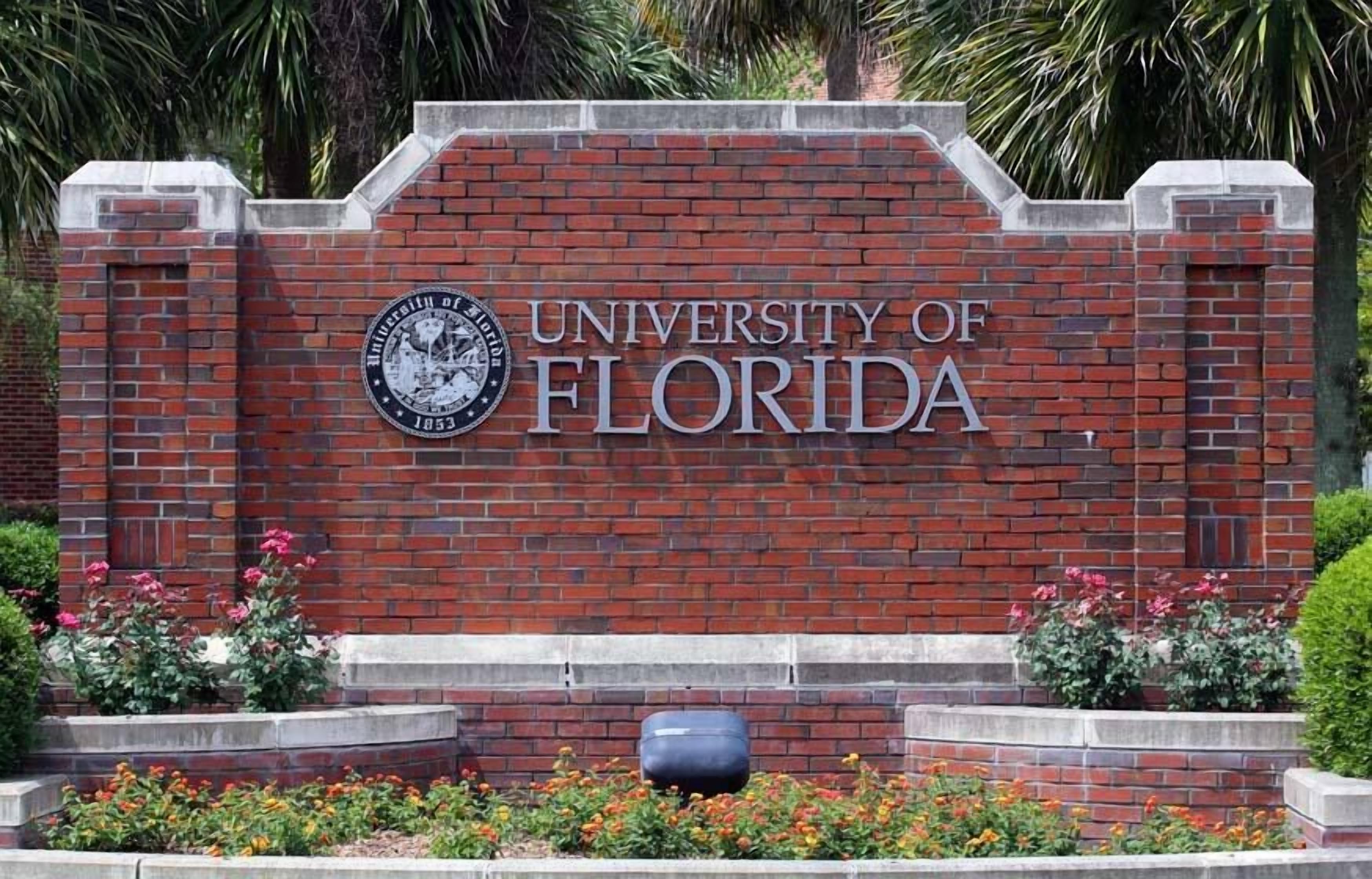A brick wall with the University of Florida logo and name.