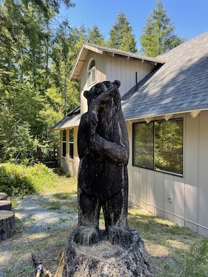 Stunning garden area with a prominent bear sculpture and lush greenery.