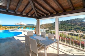 Relax by the pool in a serene outdoor space with a clear view of the surrounding landscape.