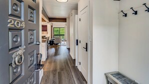 A hallway with a wooden floor, white walls, and a door labeled "204". - 🏔️Incredible Mtn Views & Ski Access~Hot Tub~Interlude 204🏔️ (Snowmass Village)