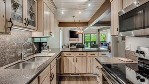 A modern kitchen with granite countertops, stainless steel appliances, and wooden cabinetry. - 🏔️Incredible Mtn Views & Ski Access~Hot Tub~Interlude 204🏔️ (Snowmass Village)