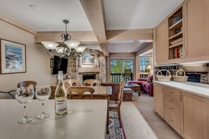 A spacious living room with a fireplace, wooden furniture, and a view of the outdoors.