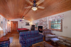 A cozy living room with a pool table, a fireplace, a sofa, and a recliner. - Private Family Mountain Getaway- Dog Friendly! (Fairplay)