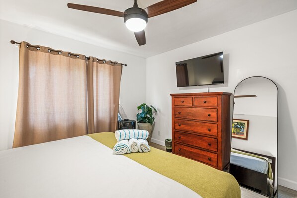 The bedroom has a TV and a full dresser alongside the king bed, so you can settle in and actually stay a while.