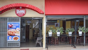 A restaurant with a red awning and a sign for 'ORISON MANAGUA'. - Orison Managua (Managua)
