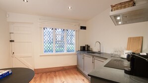 A kitchen with a window, a sink, and a countertop. - Coventry Historic Houses (Coventry)
