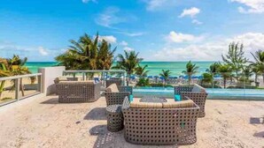 A beachside lounge with wicker furniture and a view of the ocean. - Oceanview Apt at Marenas Resort, Sunny Isles Beach with Direct Beach Access!  (Sunny Isles Beach)
