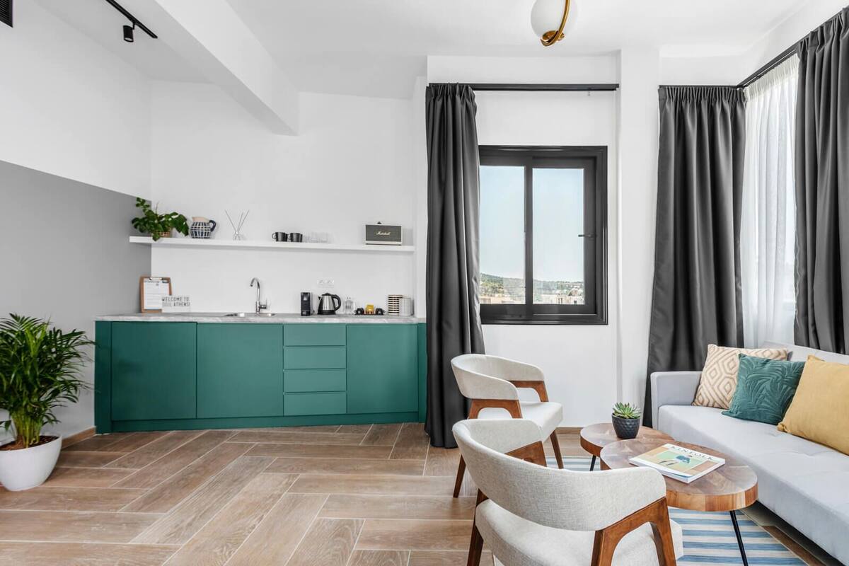 A modern apartment with a kitchen, dining area, and living room.