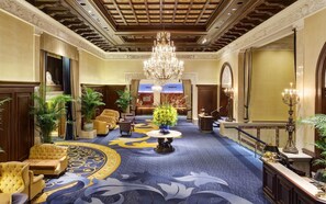 A grand lobby with a chandelier, plush seating, and a patterned carpet. - 2 Connecting Suites at a 4⭐️ Hotel (Chicago)