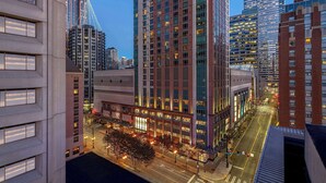 A high-rise building with multiple floors, large windows, and a modern architectural design. - 2 Connecting Suites at a 4.5⭐️ Hotel (Seattle)