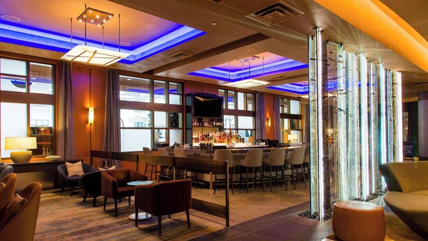 A modern hotel lobby with a bar area, seating arrangements, and large windows. - 2 Connecting Suites at a 4.5⭐️ Hotel (Seattle)