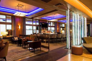 A modern hotel lobby with a bar area, seating arrangements, and large windows. - 2 Connecting Suites at a 4.5⭐️ Hotel (Seattle)