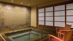 A spa area with a tiled wall, a pool, a wooden chair, and a window with frosted glass. - 2 Connecting Suites at a 4.5⭐️ Hotel (Seattle)