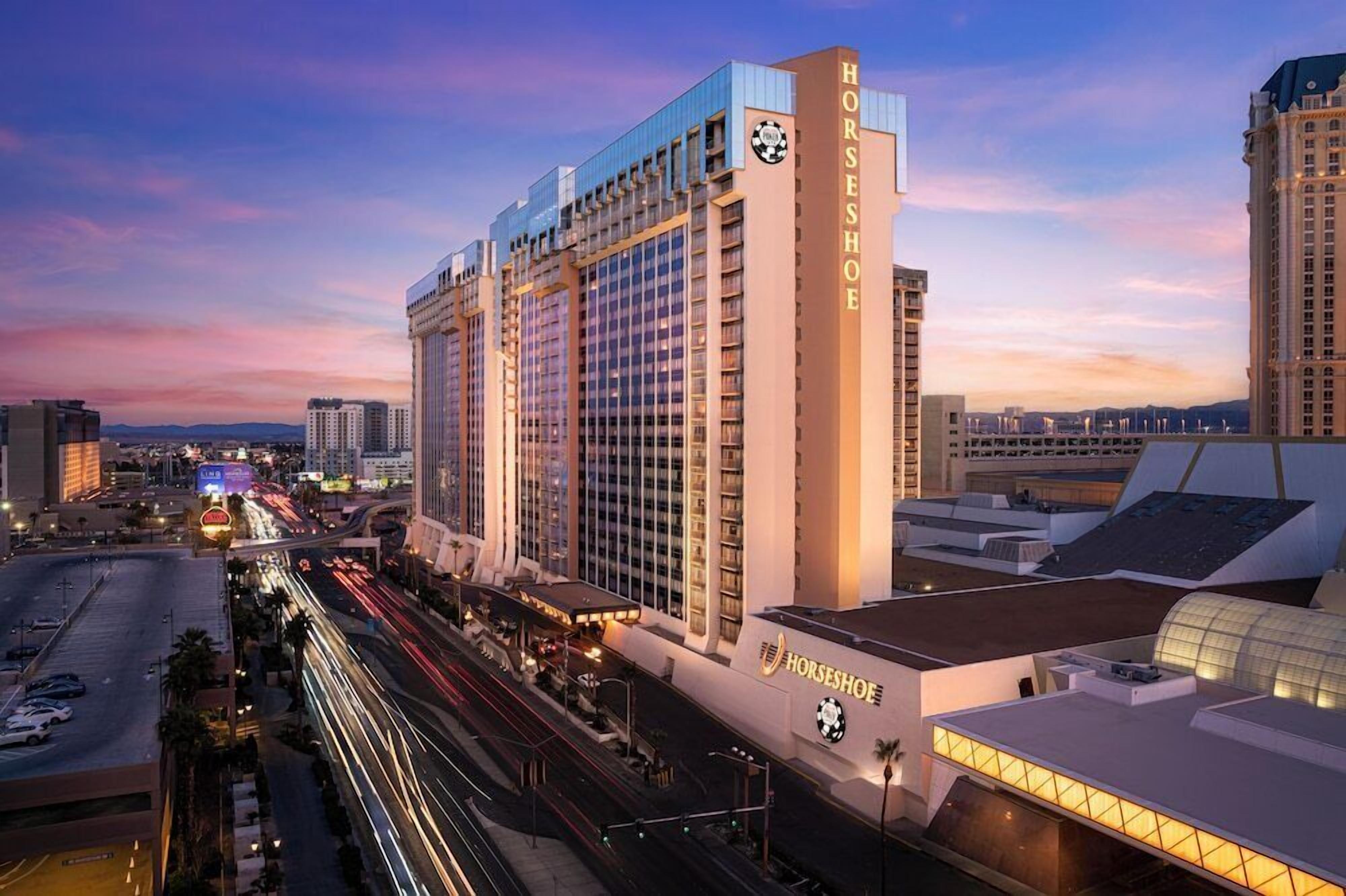 A high-rise hotel with a prominent sign reading "HORSESHOE" and a large logo on the facade.