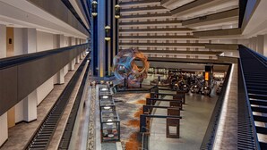 A modern interior with a central spiral staircase, multiple levels, and a patterned floor. - Suite + Connecting Room at a 4⭐️ Hotel (San Francisco)
