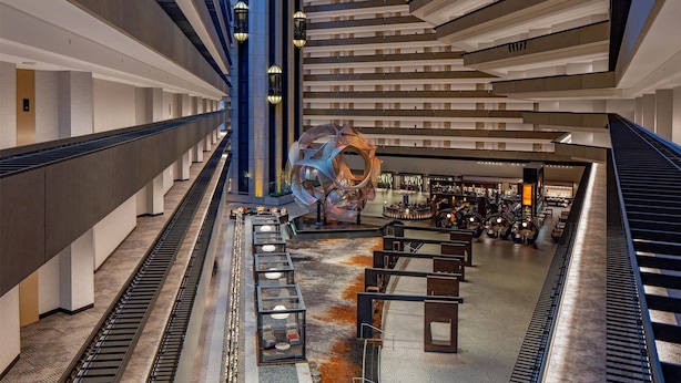 A modern interior with a central spiral staircase, multiple levels, and a patterned floor.