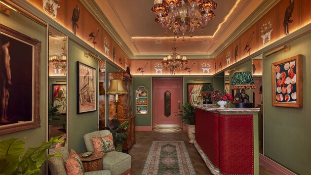 A hallway with a red bar, green walls, and a patterned rug. - Broadwick Soho (London)