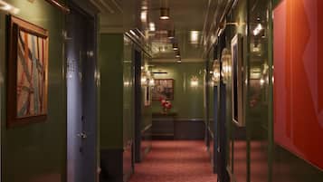 A hallway with a carpeted floor, a door with the number 41, and a framed artwork on the left.