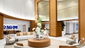 A spacious lobby with a central seating area, a reception desk, and a large window. - 2 Connecting Suites at a 5⭐️ Hotel (Fort Lauderdale)