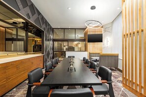 A conference room with a long table, chairs, a whiteboard, and a modern interior design. - 2 Connecting Suites at a 4⭐️ Hotel (Seattle)