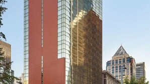 A high-rise building with a prominent red facade and reflective glass windows. - 2 Connecting Suites at a 4⭐️ Hotel (Seattle)