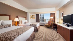 A hotel room with two beds, a desk, a television, and a window with a city view. - 2 Connecting Suites at a 4⭐️ Hotel (Seattle)