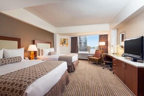 A hotel room with two beds, a desk, a television, and a window with a city view. - 2 Connecting Suites at a 4⭐️ Hotel (Seattle)