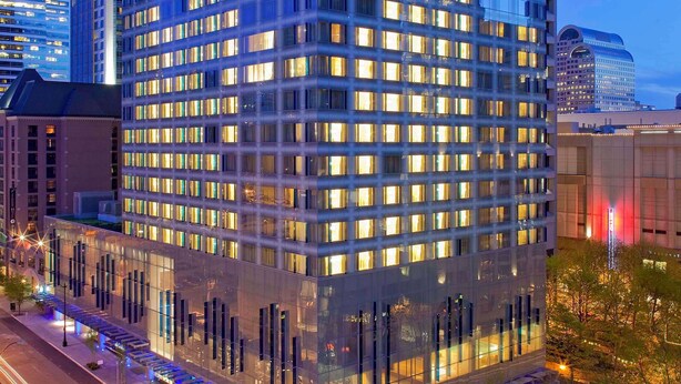 A high-rise building with multiple floors, large windows, and a modern architectural design. - 2 Connecting Suites at a 4⭐️ Hotel (Seattle)