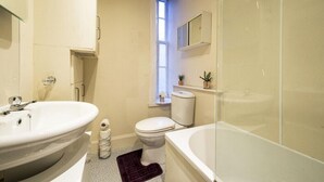 A compact bathroom with a sink, toilet, and bathtub. - Morrison Central ApartHotel Edinburgh (Edinburgh)