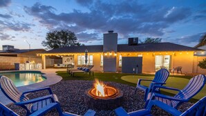 A backyard with a swimming pool, outdoor seating, and a fire pit. - Scottsdale Kierland Oasis: Heated Pool, Golf & More (Scottsdale)