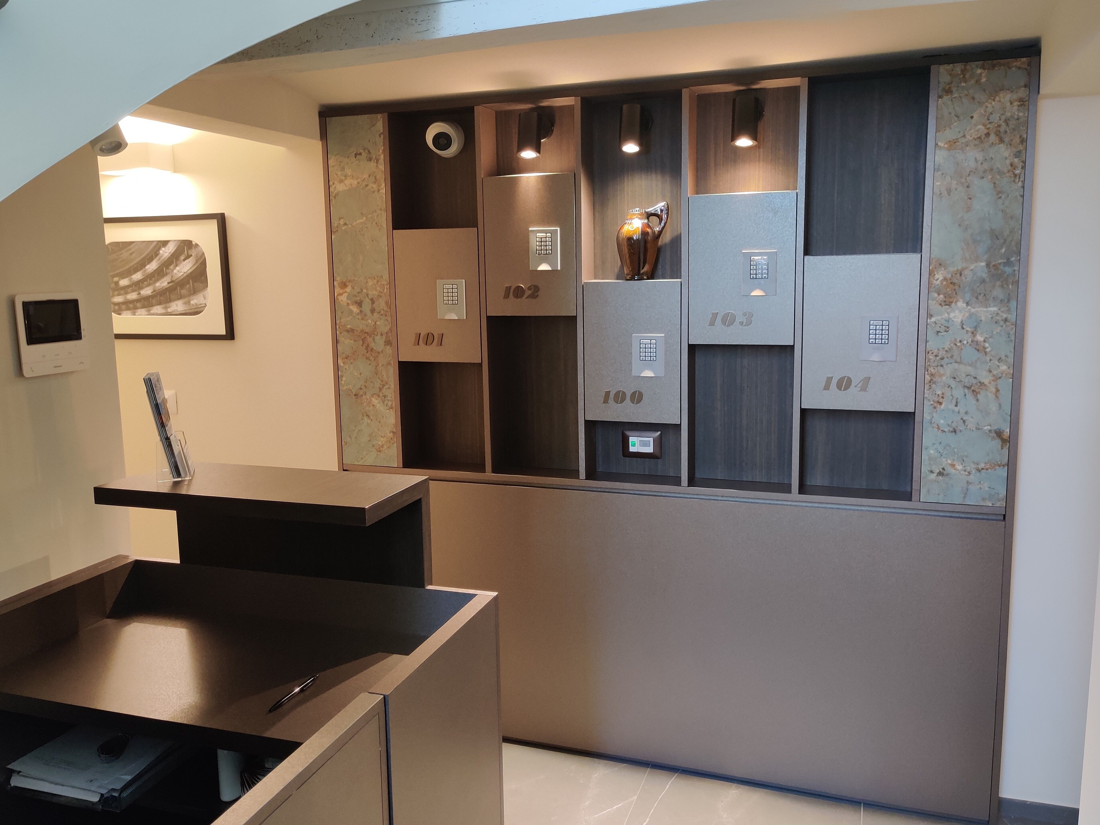 A modern elevator with numbered doors, a digital display, and a security camera.