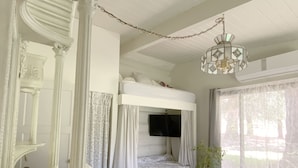 A bedroom with a four-poster bed, a bunk bed, and a chandelier. - Meadowlands Cottage, Horse Ranch with Wood Burning Stove and a River, Hot Tub (kernville)