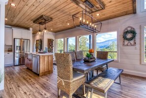 A spacious kitchen with wooden cabinets and a stainless steel refrigerator.