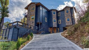 A multi-story building with a stone facade and a dark blue exterior.