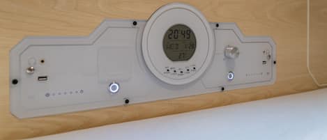 A digital thermostat with a display showing the time as 20:49 and the date as Wed 1/28.