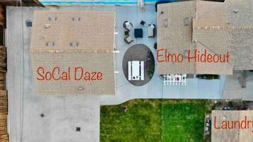 An aerial view of a residential area with labeled sections: SoCal Daze, Elmo Hideout, and Laundry.